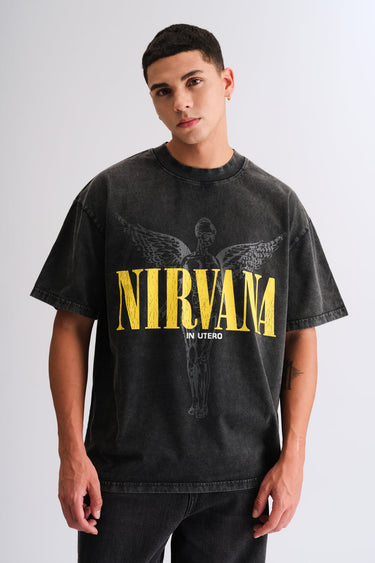 Man wearing a black Nirvana oversized graphic t shirt styled for a casual streetwear look. A cool example of men’s Valentine’s Day outfit ideas, showcasing a relaxed Valentine’s Day outfit men can wear for an effortless dinner date style.