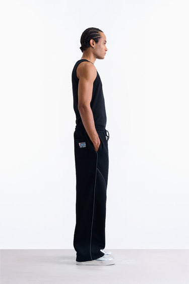 Bonkerscorner UAE Pitlane Straight Track Pants shown on a model, featuring sporty design and comfortable fit in a sleek style.