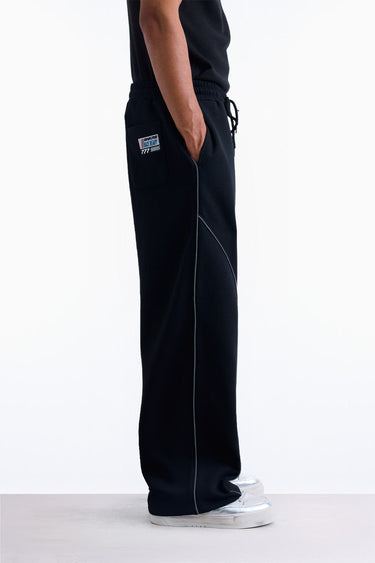 Bonkerscorner UAE Pitlane Straight Track Pants displayed on a model, showcasing their sporty design and sleek fit.
