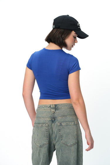 Bonkers Corner Aries Aura long length baby tee in soft fabric with graphic print, displayed on a neutral background.