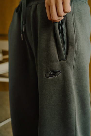 Ash Olive Bonkers Corner On The Go Joggers in XS, showing olive green jogger pants with relaxed fit and drawstring waist.
