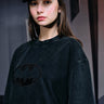Faded black oversized T-shirt with a bat emblem design from Bonkers Corner, casual streetwear style.