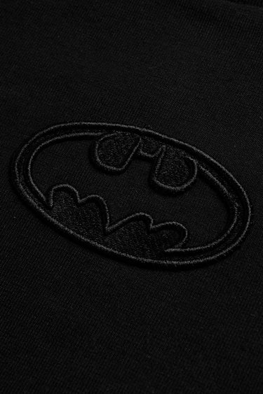 Faded black oversized T-shirt with a Bat emblem graphic from Bonkers Corner, casual streetwear style.