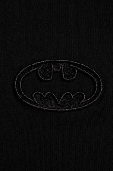 Faded black oversized T-shirt by Bonkers Corner featuring a bat emblem graphic on the front.