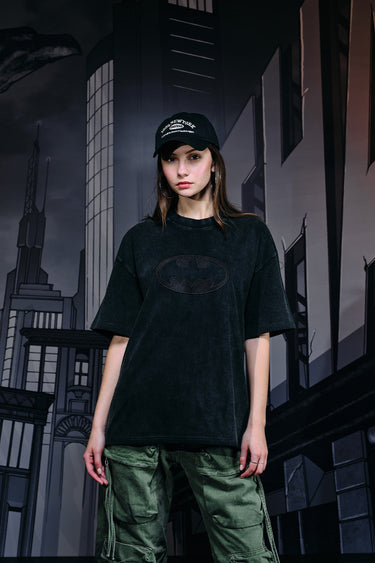Faded black oversized T-shirt with bat emblem graphic from Bonkers Corner, casual streetwear style.