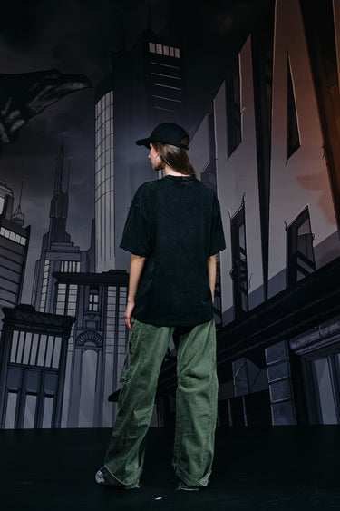 Faded oversized T-shirt by Bonkers Corner featuring a large bat emblem on the front, soft cotton fabric, and relaxed fit.