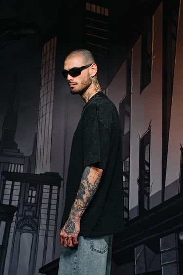 Faded oversized T-shirt by Bonkers Corner featuring a bat emblem design on the front, casual streetwear style.