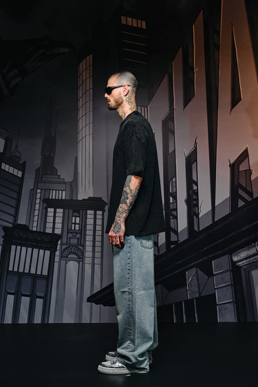 Faded oversized T-shirt by Bonkers Corner featuring a bat emblem graphic on the front, casual streetwear style.