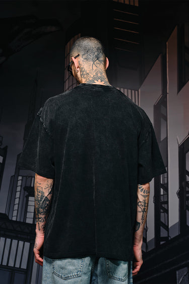 Faded oversized T-shirt by Bonkers Corner with a bat emblem design on the front, casual streetwear style.