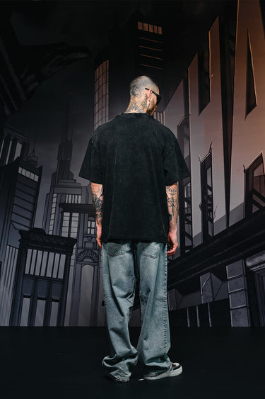 Faded oversized T-shirt with bat emblem design by Bonkers Corner, featuring a relaxed fit and vintage-inspired style.