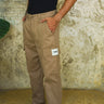 Beige cargo pants with utility pockets from Bonkers Corner, featuring a casual fit and functional design.