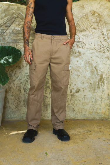 Beige cargo pants with utility pockets by Bonkers Corner, featuring a relaxed fit and functional pocket details.