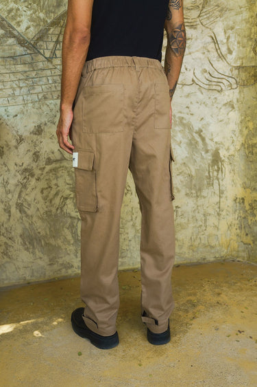 Beige cargo pants with utility pockets by Bonkers Corner, featuring a relaxed fit and multiple functional pockets.