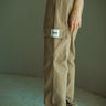 Beige cargo pants with utility pockets from Bonkers Corner, showcasing relaxed fit and functional design.