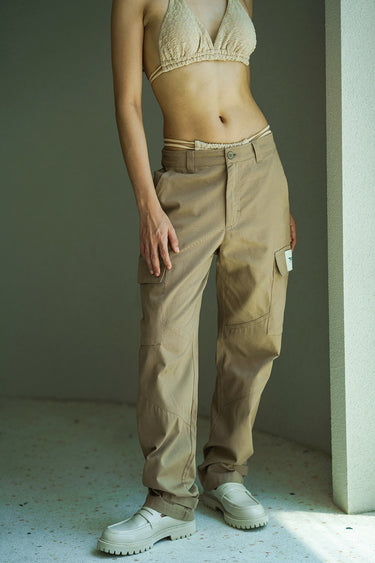 Beige cargo pants with utility pockets from Bonkers Corner, featuring multiple functional pockets and a casual fit.