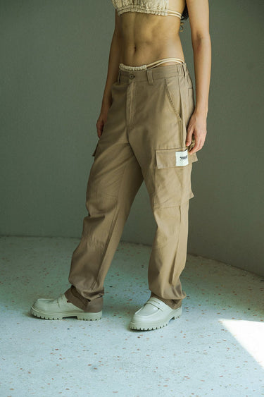 Beige cargo pants with utility pockets from Bonkers Corner, featuring a relaxed fit and functional design for casual wear.