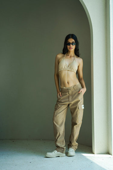 Beige cargo pants with utility pockets from Bonkers Corner, featuring multiple functional pockets and casual fit.