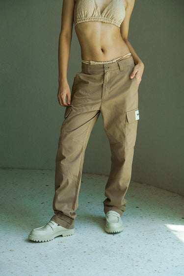 Beige cargo pants with utility pockets from Bonkers Corner, featuring a relaxed fit and functional design for casual wear.