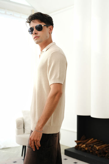 Beige knit textured polo T-shirt by Bonkers Corner, close-up showing fabric details and classic collar design.
