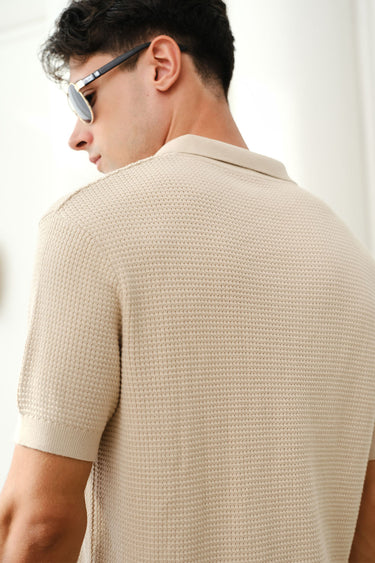 Beige knit textured Polo T-shirt by Bonkers Corner, showcasing a classic collar and short sleeves on a plain background.