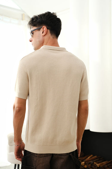 Beige knit textured polo T-shirt by Bonkers Corner, close-up of fabric with classic collar and short sleeves.