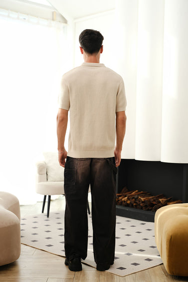 Beige knit textured polo T-shirt by Bonkers Corner, close-up of fabric and collar detail on a casual men's shirt.
