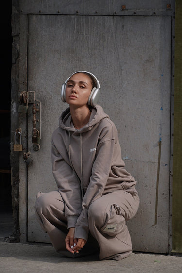 Beige limited edition hoodie by Bonkers Corner, shown on a hanger, featuring a soft fabric and minimalistic design.