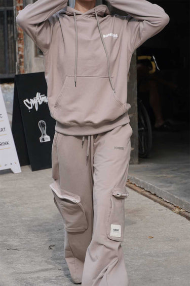 Beige limited edition hoodie from Bonkers Corner with a relaxed fit and subtle branding, displayed on a hanger.