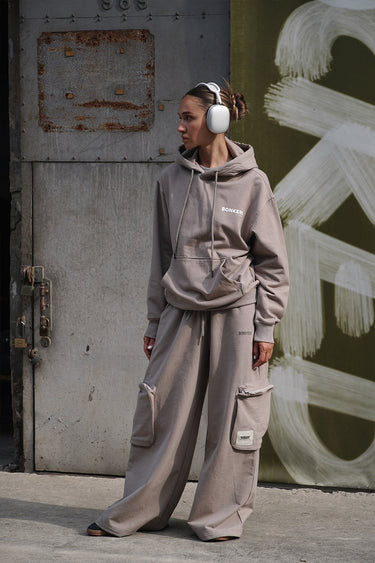 Beige limited edition hoodie by Bonkers Corner, featuring a cozy fit and stylish design, displayed on a hanger.
