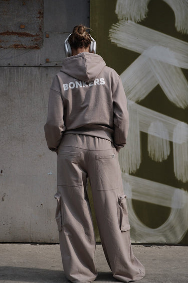 Beige limited edition hoodie by Bonkers Corner, featuring a cozy fit and minimalist design, shown on a model.