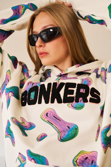 Beige Smiley Originals hoodie by Bonkers Corner featuring a playful smiley face design on soft fabric.