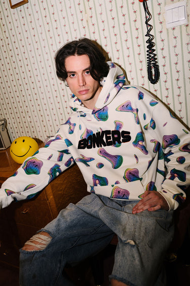 Beige Smiley Originals hoodie by Bonkers Corner featuring a playful smiley face design on soft fabric.
