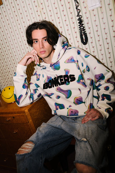 Beige Smiley Originals hoodie by Bonkers Corner with a playful smiley face graphic on the front. Comfortable casual wear.