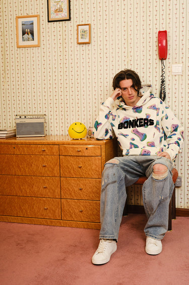 Beige Smiley Originals hoodie by Bonkers Corner featuring a relaxed fit and graphic smiley face design.