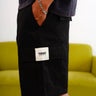 Black authentic utility shorts by Bonkers Corner, with durable fabric and multiple pockets, shown on a model.