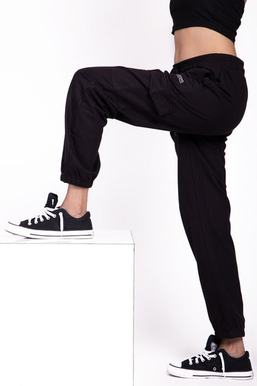 Black cargo pants by Bonkers Corner featuring multiple pockets and a relaxed fit, worn as casual streetwear.