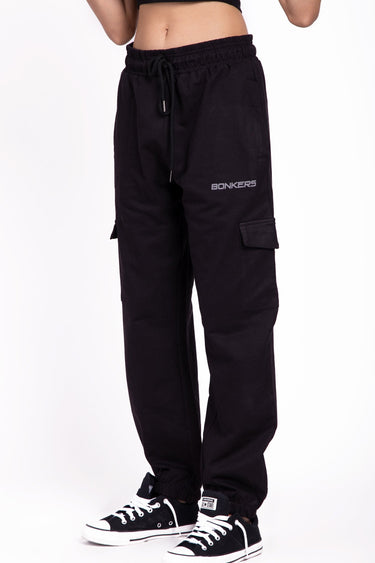 Black cargo pants from Bonkers Corner with multiple pockets and a relaxed fit, shown on a model.