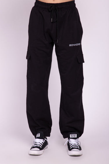 Black cargo pants from Bonkers Corner with multiple pockets and a relaxed fit, shown on a model.