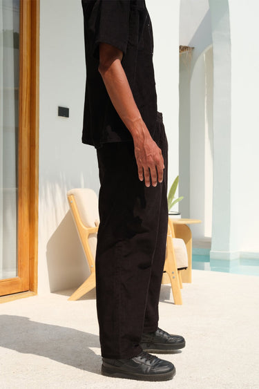 Black corduroy pants by Bonkers Corner, featuring a slim fit design with classic corduroy texture.