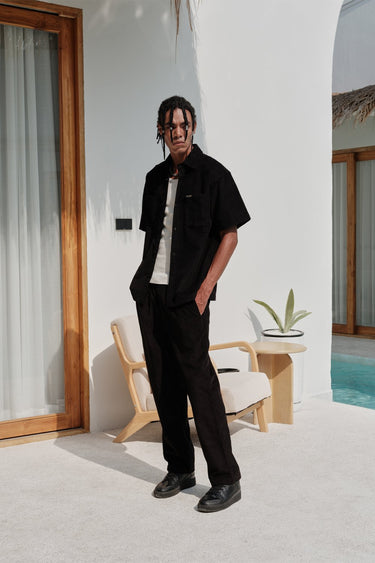 Black corduroy pants by Bonkers Corner, slim-fit style with textured fabric and classic waistband detail.