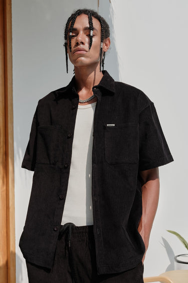 Black corduroy shirt from Bonkers Corner, featuring a classic button-up style with a textured fabric look.