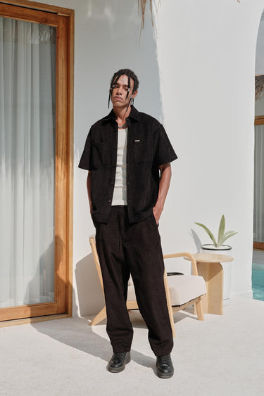 Black corduroy shirt from Bonkers Corner, shown in XS size with a classic collar and button front, textured fabric visible.