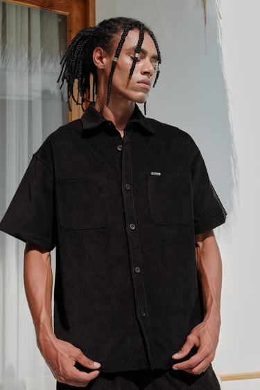 Black corduroy shirt from Bonkers Corner, featuring a classic fit and button-down design, shown on a plain background.
