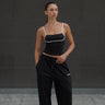 Black Essential Cami Top by Bonkers Corner, close-up of fitted camisole with thin straps and smooth fabric.