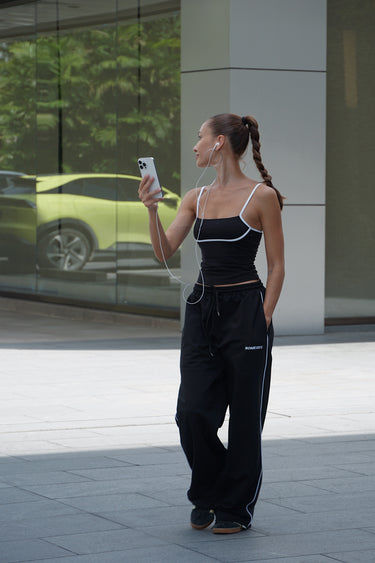 Black Essential Cami Top by Bonkers Corner, featuring a close-up of the fitted camisole with thin straps and smooth fabric.