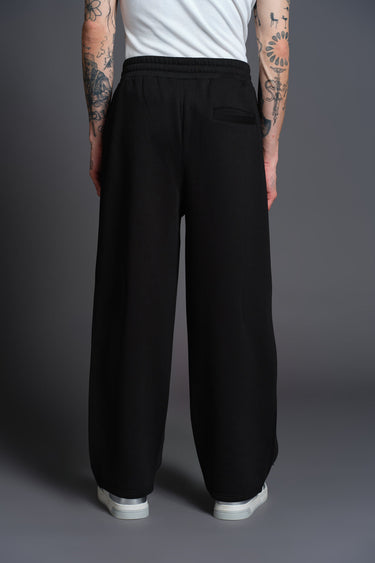 Black Bonkers Corner everyday joggers made of comfortable fabric, shown on a model with a relaxed fit and elastic waistband.