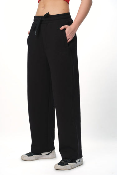Black everyday joggers from Bonkers Corner, shown on a model, featuring a relaxed fit and comfortable elastic waistband.