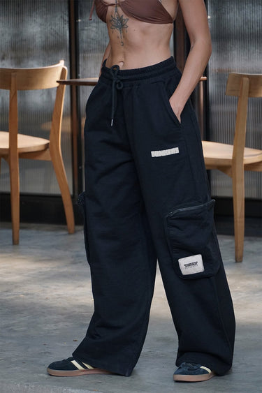 Black heavyweight cargo pants from Bonkers Corner with multiple side and back pockets, made for durable and casual wear.