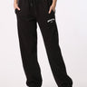 Bonkers Corner black joggers made of soft fabric, featuring an elastic waistband and tapered fit, shown on a model.