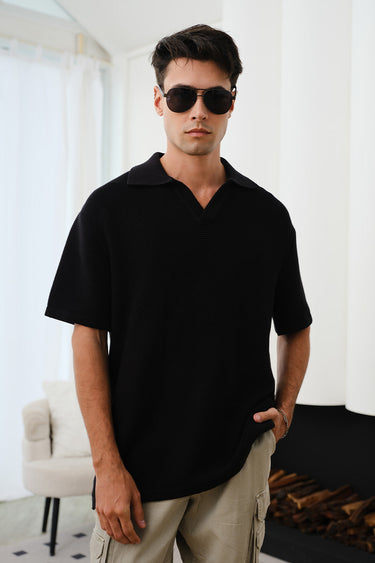 Black knit textured polo T-shirt by Bonkers Corner, showcasing a close-up of the fabric and classic polo collar.